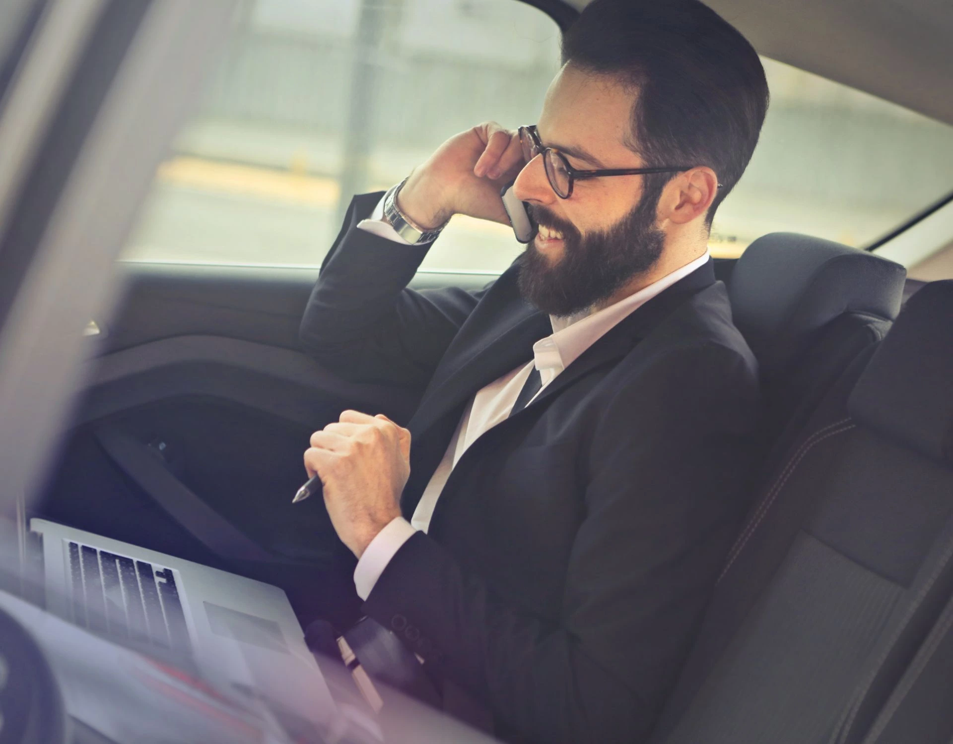 A professional chauffeur in a luxury car providing premium travel service in London.